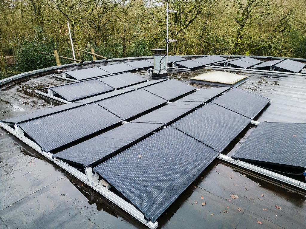 Rooftop solar panels in a natural setting, showcasing renewable energy solutions.